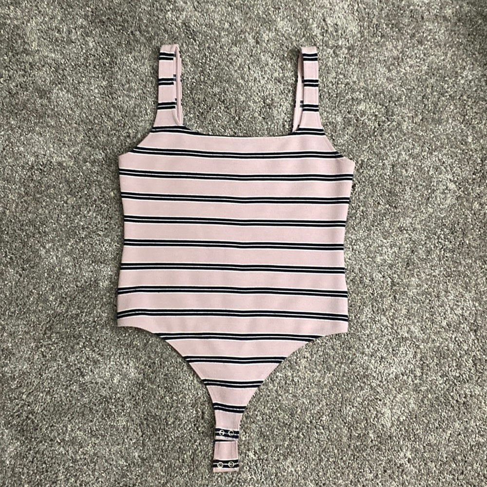 Square neck bodysuit with thong back and snap bottom.